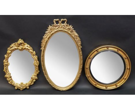 A reproduction Regency style moulded gilt frame convex wall mirror, 46cm diameter, two other gilt frame mirrors and a pottery