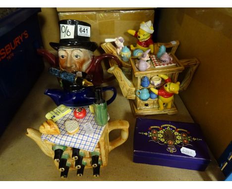 A collection of five novelty teapots, along with two vintage cardboard boxes