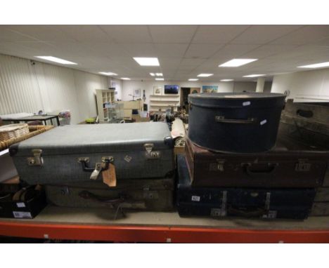 Six vintage suitcases and a hat box