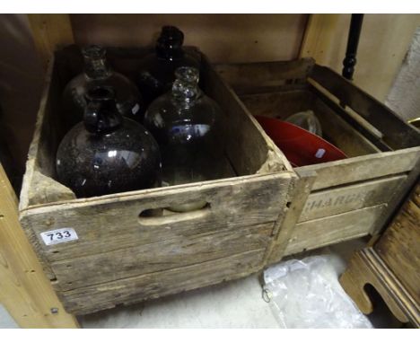Two vintage wooden crates, along with a hanging light and three glass jars