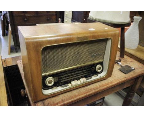 A vintage walnut cased radio by Bush