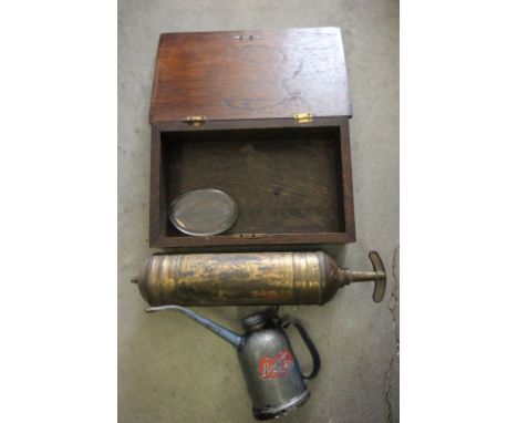 A vintage fire extinguisher, along with oil can and oak box 