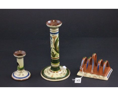 A Torquay ware candlestick, along with another candlestick and a toast rack
