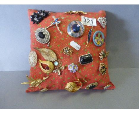 Collection of vintage brooches on a cushion