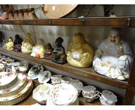 A collection of 14 Buddha's including ceramic and resin examples, along with a metal figure of a Chinese beggar