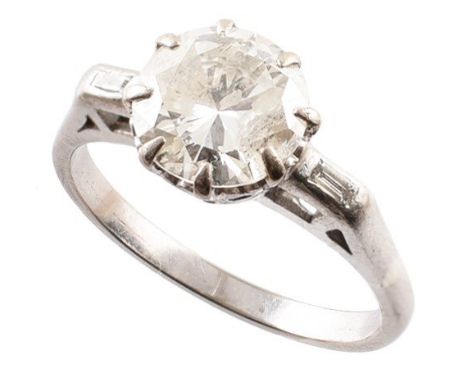 A diamond single stone ring, the brilliant cut diamond with baguette cut diamond shoulders, principal diamond estimated 1.55c
