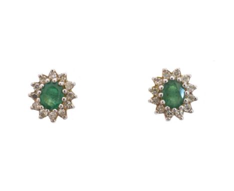 A pair of 18ct gold emerald and diamond earrings, each designed as an oval shape emerald within a single cut diamond surround