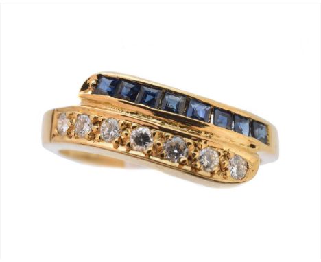 A sapphire and diamond band ring, of crossover design the square shape sapphire and brilliant cut diamond lines with tapered 