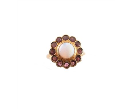 An opal and garnet cluster ring, of floral design, the circular opal cabochon within a circular shape garnet scalloped surrou