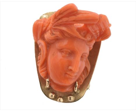 A coral brooch, depicting a carved coral classical figure within an asymmetric surround, length 3cm, gross weight 11.8g.Condi