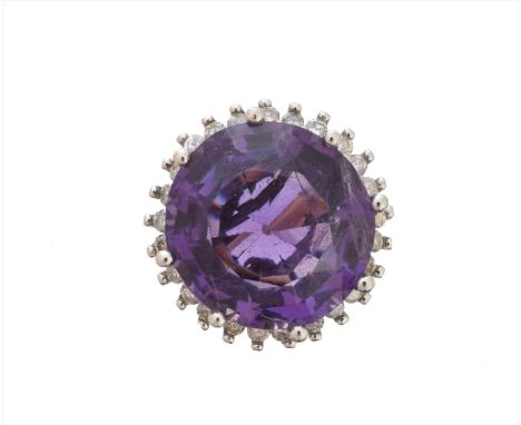 A 9ct gold amethyst and diamond cluster ring, the circular shape amethyst within a brilliant cut diamond surround, hallmarks 