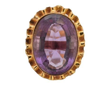 An amethyst dress ring, the oval shape amethyst within an undulating surround, ring size K1/2, gross weight 7.8g.