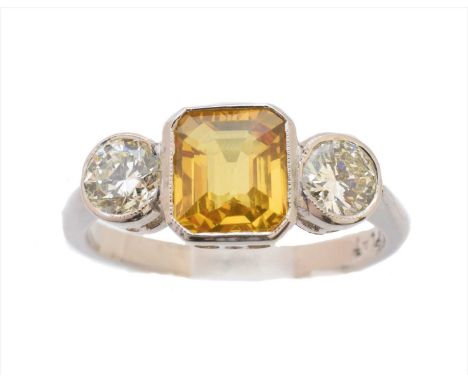 A sapphire and diamond three stone ring, the rectangular shape yellow sapphire weighing approx. 1.35cts with brilliant cut di