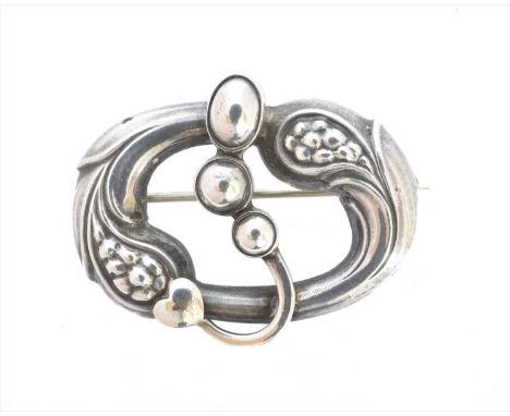 A Georg Jensen brooch, no. 77, of asymmetric design, the polished heart and beaded decoration within an openwork foliate surr