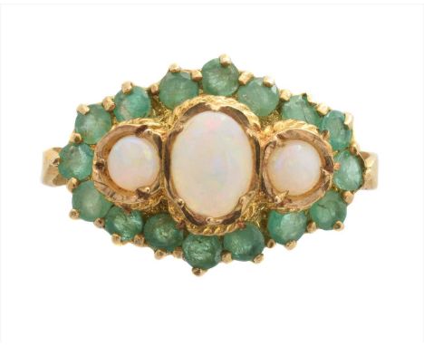 A 9ct gold opal and emerald cluster ring, the oval and circular opal cabochon line within a circular shape emerald surround, 