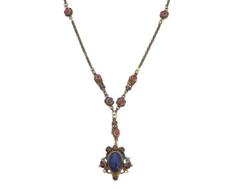 An enamel garnet ruby and lapis lazuli necklace, the oval lapis lazuli cabochon within a garnet and vari shade enamel openwor