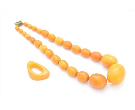 A butterscotch amber necklace, the graduated oval butterscotch amber beads with a screw clasp, together with a freeform butte