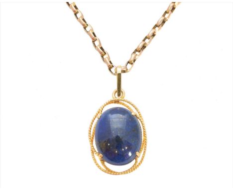 A lapis lazuli pendant, the oval lapis lazuli cabochon within an openwork surround, suspended from a trace link chain stamped