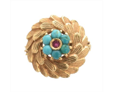 A ruby and turquoise dress ring, the circular shape ruby within a circular turquoise cabochon surround to the textured border