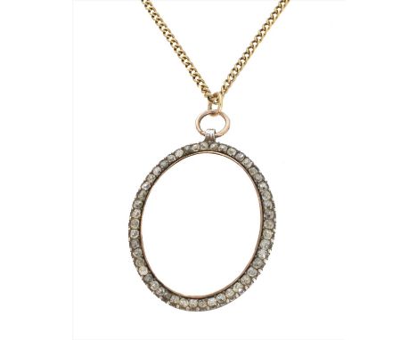 An early 20th century diamond hinged locket, the oval glazed locket within an old cut diamond surround and circular faceted s