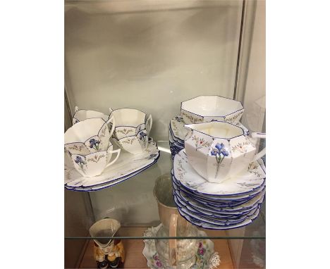 A hand painted Shelley tea service to include two service plates, twelve sandwich plates, twelve saucers, eleven tea cups, su