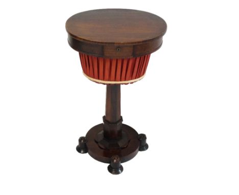 WILLIAM IV ROSEWOOD WORK TABLE
with an oval lift up lid revealing a fitted interior supported by a hexagonal column on a circ