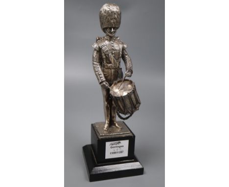 A modern silver (filled) model of a guardsman, with drum, Carrington &amp; Co, London, 1988, on wooden plinth, overall 28.3cm