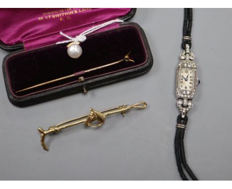 A 15ct and cultured pear dress stud, gross 2 grams, a paste set cocktail watch, a stick pin and a gilt metal riding crop broo