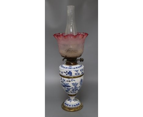 A Meissen onion pattern oil lamp, with cranberry shade