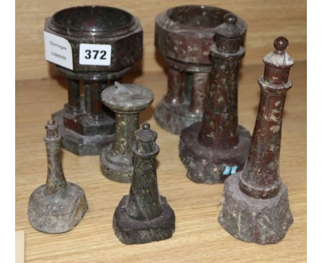 Cornish serpentine models of two fonts, four lighthouses and a sundial, tallest 18cm