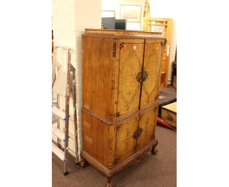 Burr walnut four door cocktail cabinet on ball and claw legs