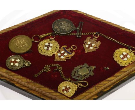 Collection of five 9 carat gold medals, two silver medals and two first world war medals, in glazed case