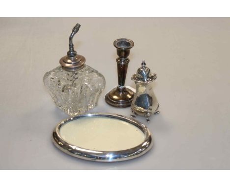 Silver mounted perfume bottle, silver pepperette, silver candlestick and a silver oval photograph frame (4)