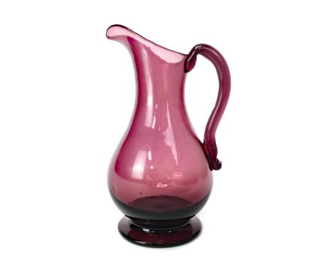 GEORGE III AMETHYST GLASS PITCHER, of footed baluster form, with applied hoop handle, 19.5cm high