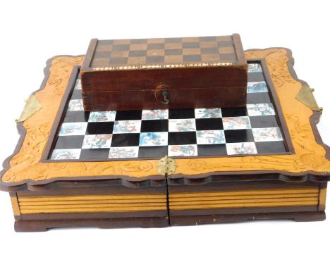 Two chess sets, comprising a Chinese camphorwood folding chess set, with engraved panels of figures and animals, and a furthe