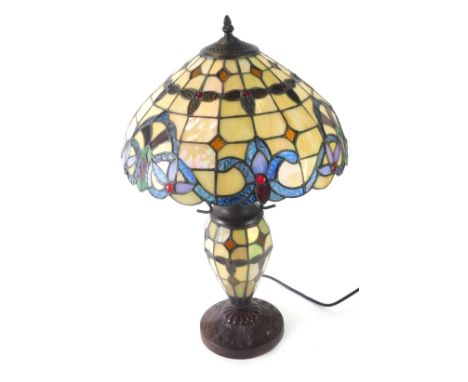 A Tiffany style table lamp, with a cream, blue and red lustre finish, with metal supports, 61cm high.