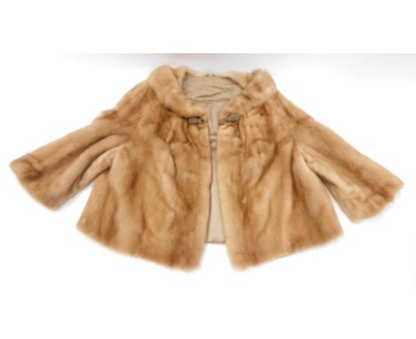 A mink cape, light brown colour, with silk lined interior bearing initials MB.