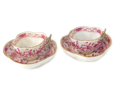 A pair of Meissen coffee cans and saucers, each with fluted and gilt rims, with pink painted flowers and blue cross marks to 
