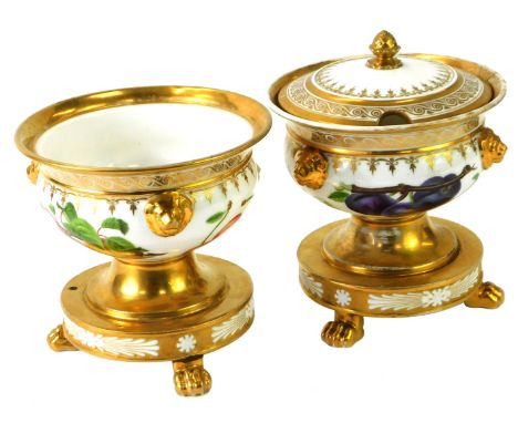 A pair of Paris porcelain urns, each with a gilt and dart moulded border and applied fruits and flowers detail, with lion mas