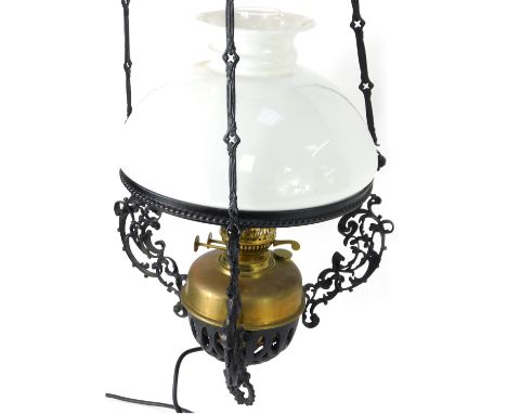 A Victorian style hanging oil lamp, with a white glass shade, and glass reservoir, with cast frame, 52cm high.