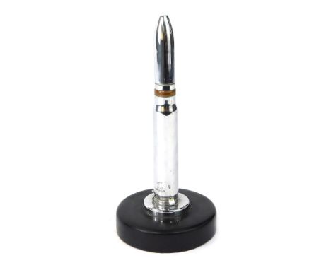 A Raleigh novelty chrome plated lighter, shaped as a bullet, on black circular base, 23cm high.