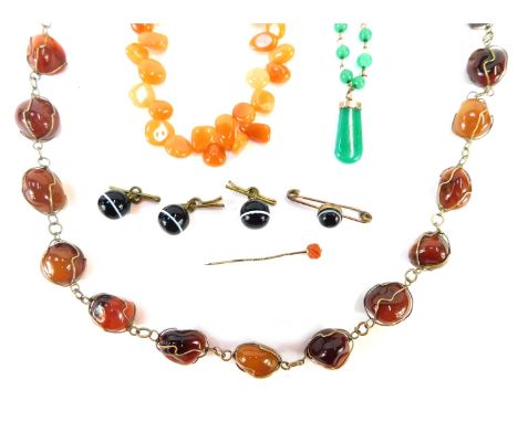 Three hard stone necklaces, comprising an orange agate and wirework necklace, 80cm long, an orange multi layer necklace, 42cm