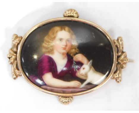A 20thC portrait brooch, central oval porcelain panel of a girl in purple dress with dog, on a floral white metal gilt border