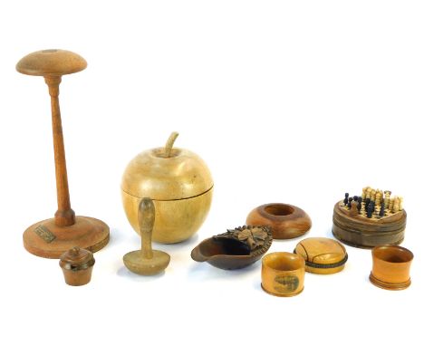A group of treen, comprising an ebony apple trinket box, a turned teak candlestick with crest from the teak of HMS Iron Duke,