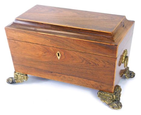 A Regency rosewood sarcophagus shaped tea caddy,  with mother of pearl key hole and brass ring handles and feet, lacking inte