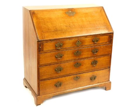 A George III oak bureau, the fall front above an arrangement of one short and three long drawers, with a fitted interior, on 
