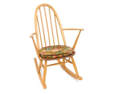An Ercol light elm rocking chair, bearing label, 77cm high, 71cm deep and 42cm wide.