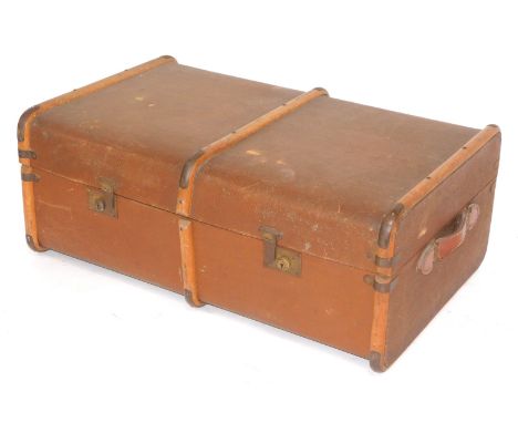A brown 20thC trunk, with teak straps, leather handles, 30cm high, 85cm wide and 53cm deep.