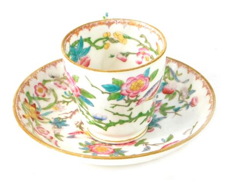 A Minton cup and saucer, profusely decorated with flowers birds and vines, marked English porcelain Minton 3934, the cup 6cm 