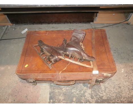 leather suitcase and a pair of vintage leather ice skates